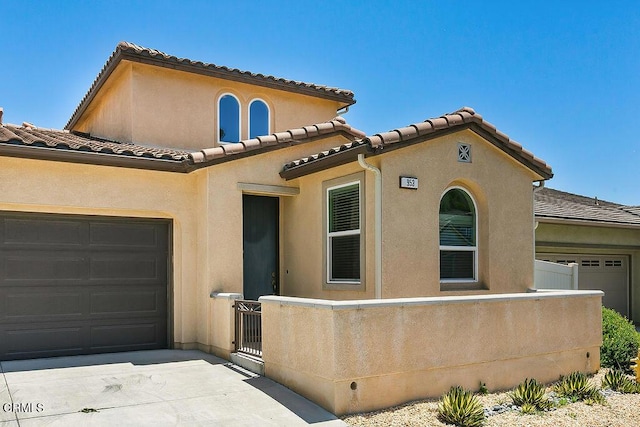 953 Coronado Cir, Santa Paula, CA 93060 - mediterranean / spanish-style home featuring a garage, a tiled roof, and stucco siding