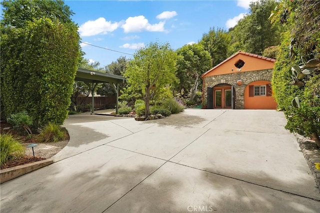 11022 Fruitland Dr, Studio City, CA 91604 - view of patio / terrace with french doors, concrete driveway, and a carport