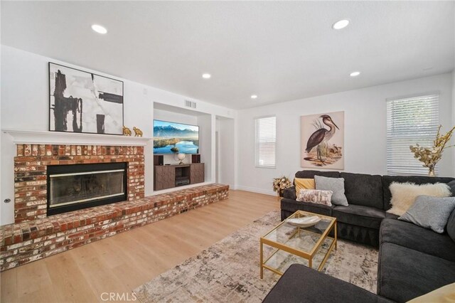 25422 Magnolia Ln, Stevenson Ranch, CA 91381 - living area with wood finished floors, a fireplace, and recessed lighting