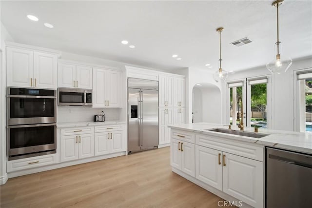 25422 Magnolia Ln, Stevenson Ranch, CA 91381 - kitchen featuring stainless steel appliances, a sink, decorative light fixtures, white cabinetry, and recessed lighting