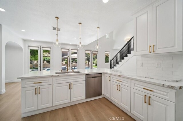 25422 Magnolia Ln, Stevenson Ranch, CA 91381 - kitchen featuring dishwasher, a sink, a peninsula, decorative backsplash, and light wood-style flooring