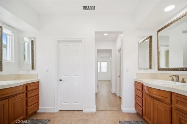 25422 Magnolia Ln, Stevenson Ranch, CA 91381 - bathroom with two vanities, tile patterned floors, and baseboards