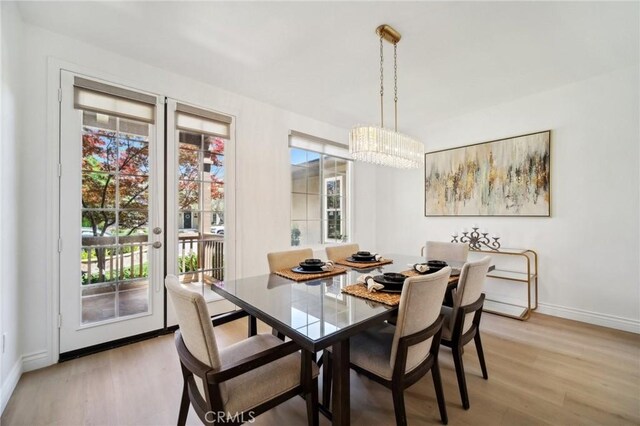 25422 Magnolia Ln, Stevenson Ranch, CA 91381 - dining room with plenty of natural light, light wood-style floors, and a chandelier