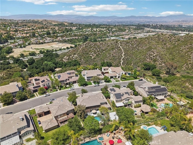 25422 Magnolia Ln, Stevenson Ranch, CA 91381 - aerial overview of property's location with a pool area, a mountain backdrop, and nearby suburban area