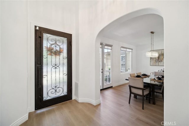 25422 Magnolia Ln, Stevenson Ranch, CA 91381 - entryway with arched walkways, wood finished floors, and baseboards