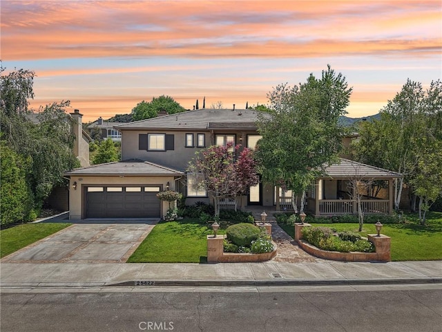 25422 Magnolia Ln, Stevenson Ranch, CA 91381 - traditional-style home featuring a front yard, concrete driveway, stucco siding, and covered porch