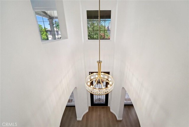 25422 Magnolia Ln, Stevenson Ranch, CA 91381 - detailed view of a chandelier, wood finished floors, arched walkways, and baseboards