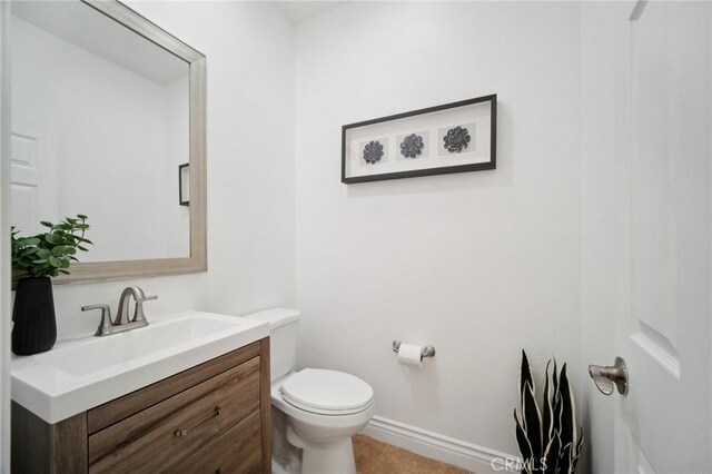 25422 Magnolia Ln, Stevenson Ranch, CA 91381 - bathroom with toilet, vanity, baseboards, and tile patterned flooring