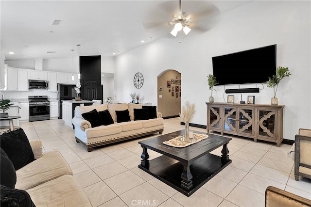 22489 Sweet Pea Rd, Oro Grande, CA 92368 - living room featuring lofted ceiling, arched walkways, light tile patterned floors, a ceiling fan, and recessed lighting
