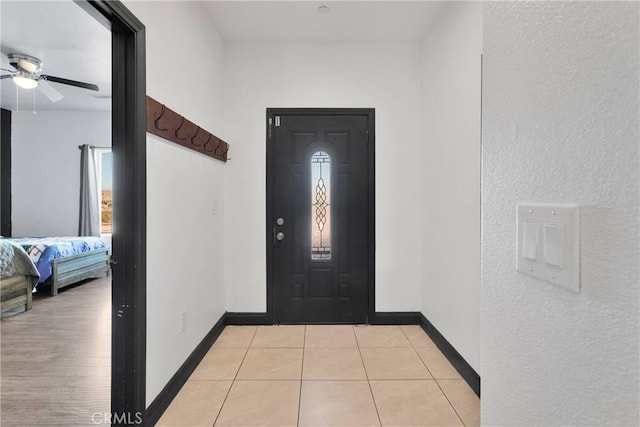 22489 Sweet Pea Rd, Oro Grande, CA 92368 - entryway featuring a ceiling fan, baseboards, and light tile patterned flooring