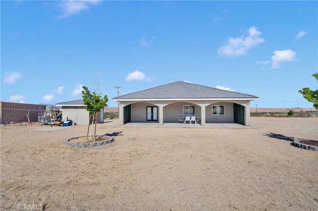 22489 Sweet Pea Rd, Oro Grande, CA 92368 - rear view of property featuring stucco siding and a patio area