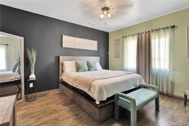 22489 Sweet Pea Rd, Oro Grande, CA 92368 - bedroom featuring multiple windows, wood finished floors, baseboards, and ceiling fan