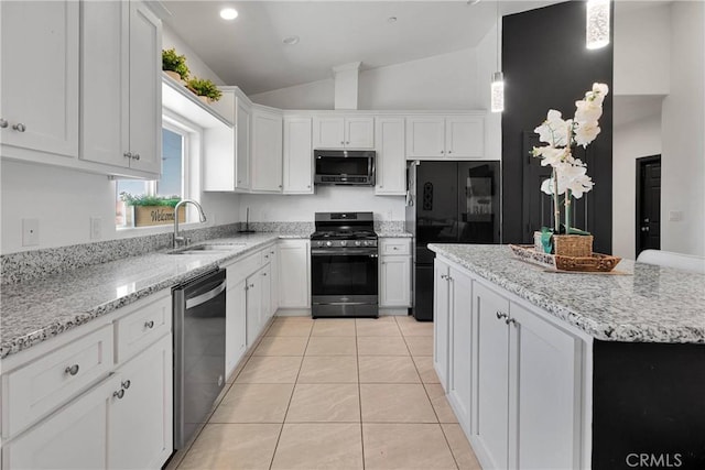 22489 Sweet Pea Rd, Oro Grande, CA 92368 - kitchen featuring appliances with stainless steel finishes, a sink, vaulted ceiling, white cabinetry, and light tile patterned flooring