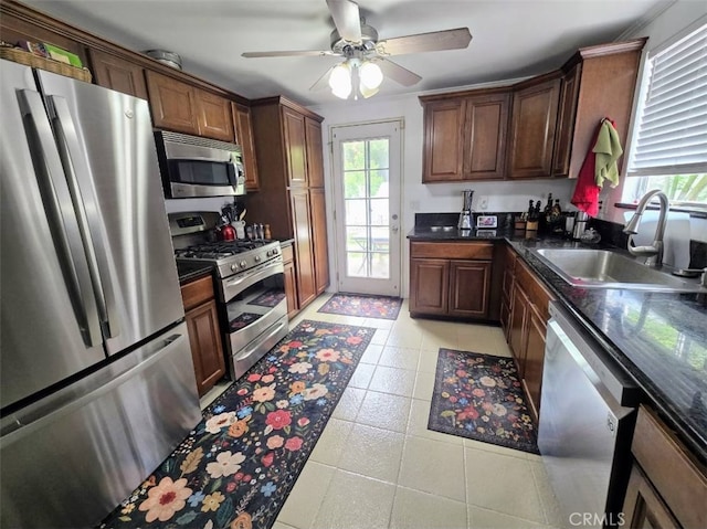 3738 Danmont Ct, Newbury Park, CA 91320 - kitchen featuring stainless steel appliances, a sink, dark countertops, ceiling fan, and light tile patterned floors