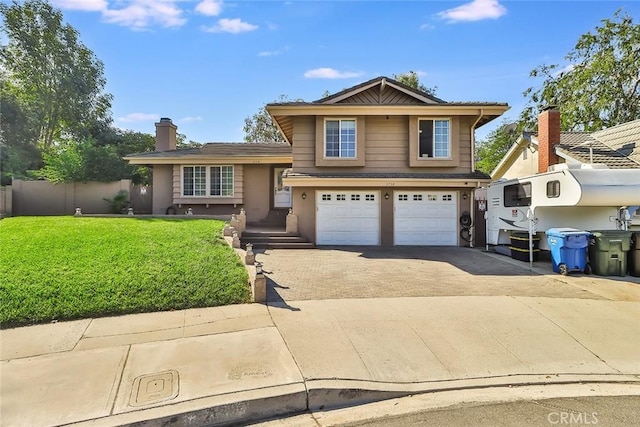 3738 Danmont Ct, Newbury Park, CA 91320 - tri-level home with asphalt driveway, an attached garage, a chimney, and stucco siding
