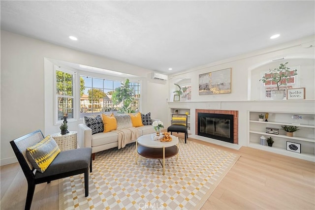 3825 Welland Ave, Los Angeles, CA 90008 - living room featuring a brick fireplace, a wall unit AC, wood finished floors, recessed lighting, and built in features