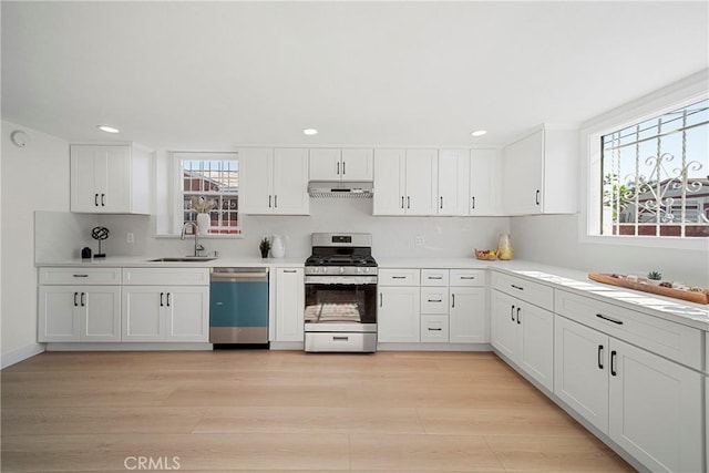 3825 Welland Ave, Los Angeles, CA 90008 - kitchen featuring appliances with stainless steel finishes, under cabinet range hood, a sink, plenty of natural light, and recessed lighting