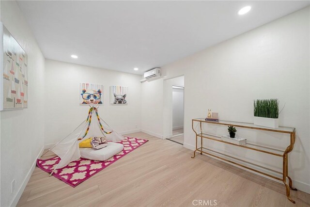 3825 Welland Ave, Los Angeles, CA 90008 - game room with an AC wall unit, wood finished floors, baseboards, and recessed lighting