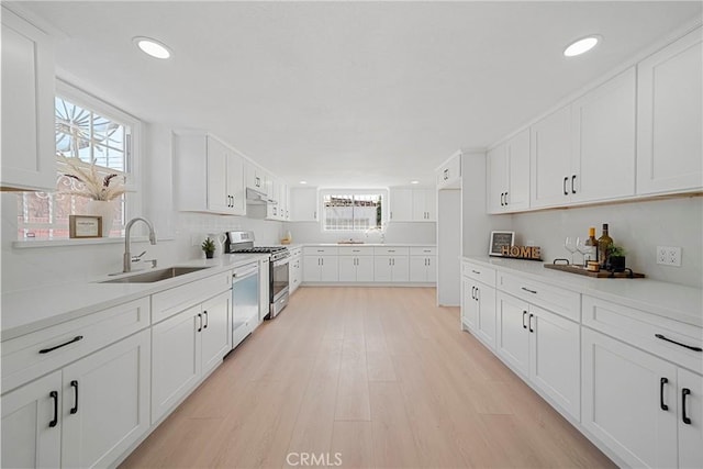 3825 Welland Ave, Los Angeles, CA 90008 - kitchen featuring a sink, appliances with stainless steel finishes, healthy amount of natural light, light wood-style floors, and recessed lighting