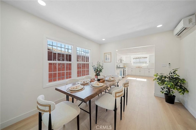 3825 Welland Ave, Los Angeles, CA 90008 - dining room featuring a wall mounted air conditioner, light wood finished floors, plenty of natural light, recessed lighting, and baseboards