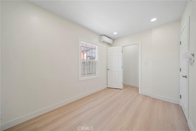 3825 Welland Ave, Los Angeles, CA 90008 - unfurnished bedroom featuring a wall mounted AC, light wood finished floors, baseboards, and recessed lighting