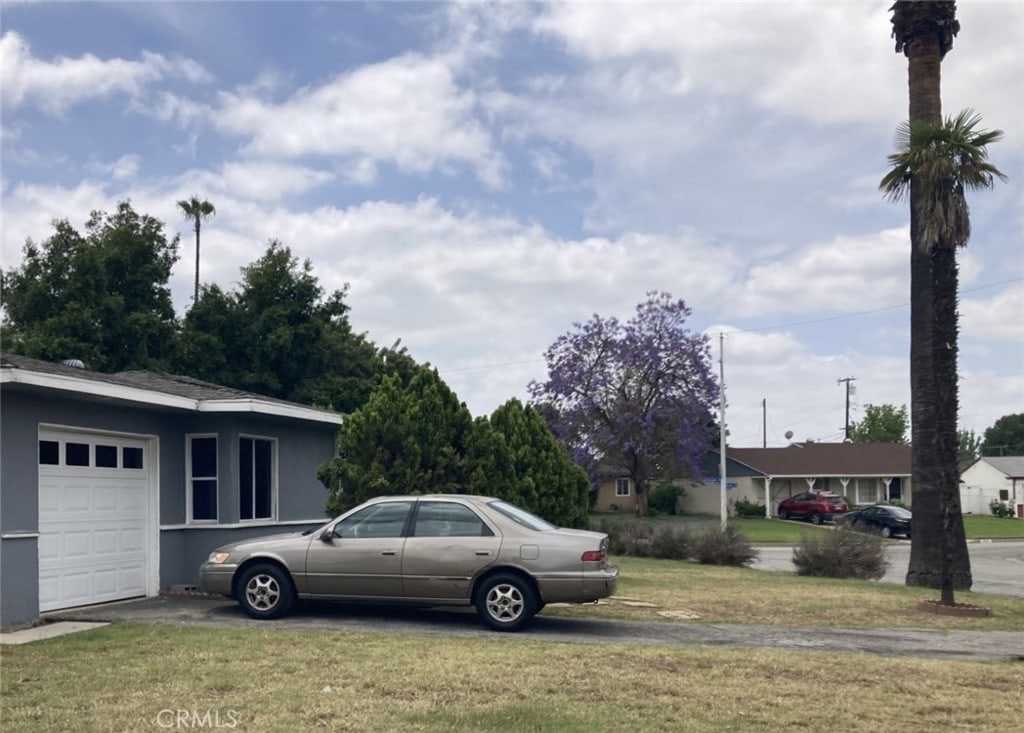 4646 N Calvados Ave, Covina, CA 91722 - view of grassy yard with an attached garage and driveway