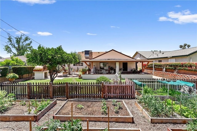 12713 16th St, Chino, CA 91710 - back of property featuring a garden, a patio area, and stucco siding