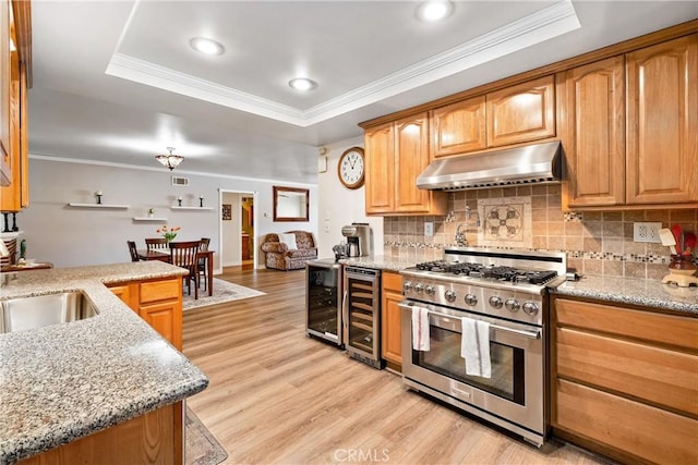 12713 16th St, Chino, CA 91710 - kitchen with under cabinet range hood, high end range, beverage cooler, a raised ceiling, and crown molding