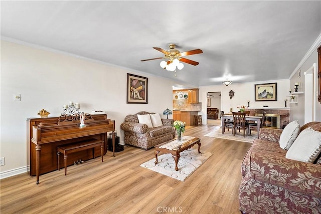 12713 16th St, Chino, CA 91710 - living room featuring a ceiling fan, crown molding, light wood-style floors, and baseboards