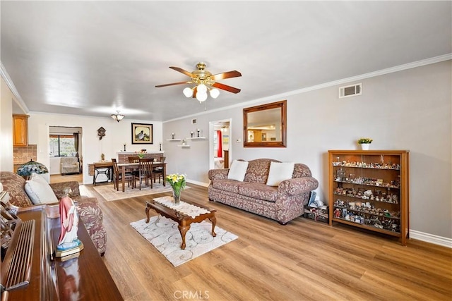12713 16th St, Chino, CA 91710 - living room featuring ceiling fan, light wood-style flooring, ornamental molding, and baseboards
