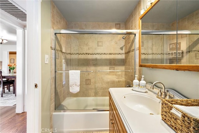 12713 16th St, Chino, CA 91710 - full bathroom with vanity, bath / shower combo with glass door, and wood finished floors