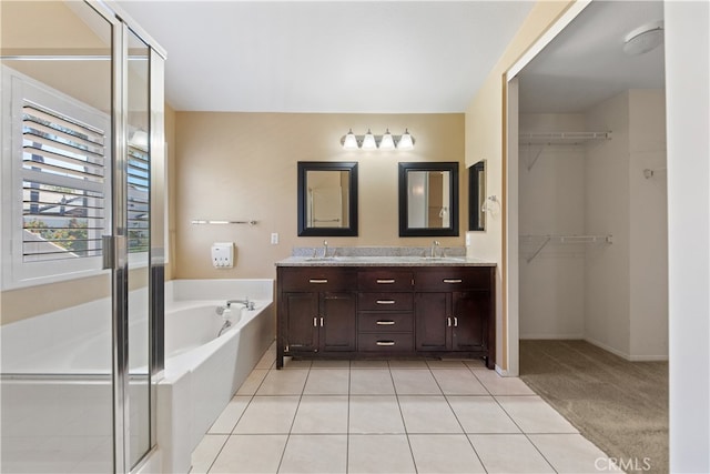 24030 Colmar Ln, Murrieta, CA 92562 - bathroom featuring a bath, double vanity, a shower stall, a walk in closet, and tile patterned flooring