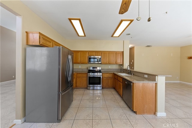 24030 Colmar Ln, Murrieta, CA 92562 - kitchen featuring stainless steel appliances, a peninsula, a sink, light tile patterned floors, and baseboards