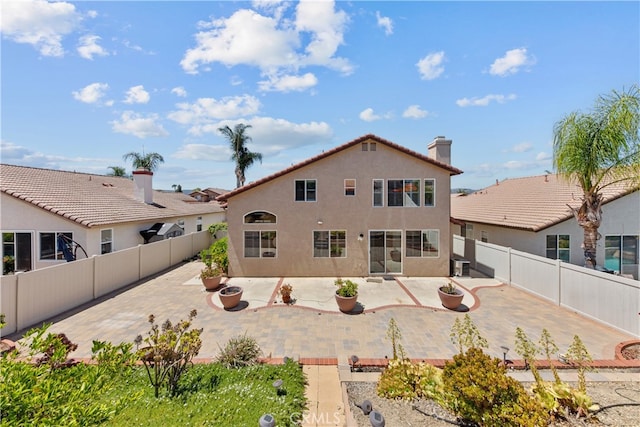 24030 Colmar Ln, Murrieta, CA 92562 - back of property featuring a fenced backyard, stucco siding, and a patio
