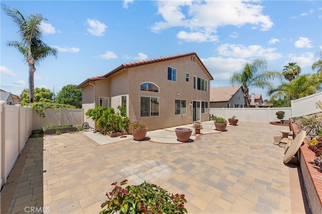 24030 Colmar Ln, Murrieta, CA 92562 - back of house with stucco siding, a fenced backyard, and a patio