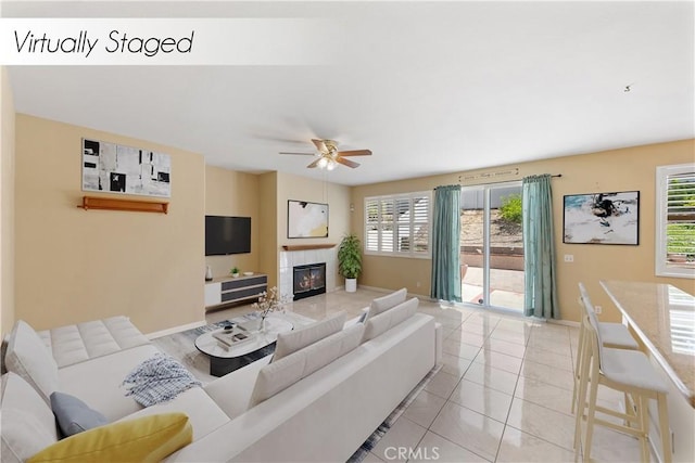 24030 Colmar Ln, Murrieta, CA 92562 - living area with a tiled fireplace, ceiling fan, baseboards, and light tile patterned flooring