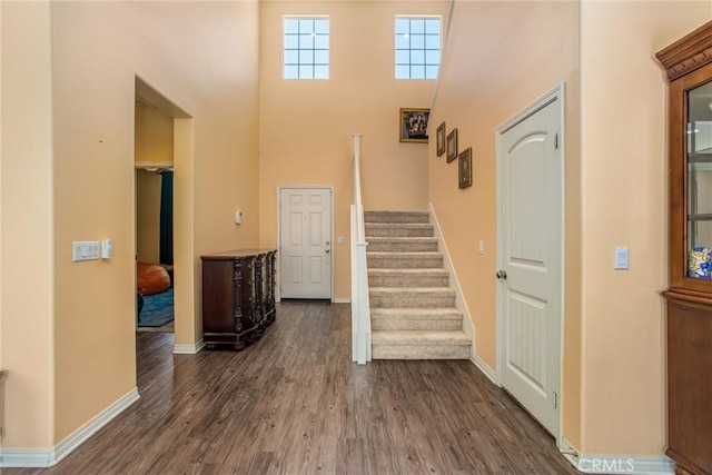 11294 Chappell Way, Beaumont, CA 92223 - foyer entrance with stairway, a high ceiling, dark wood-type flooring, and baseboards