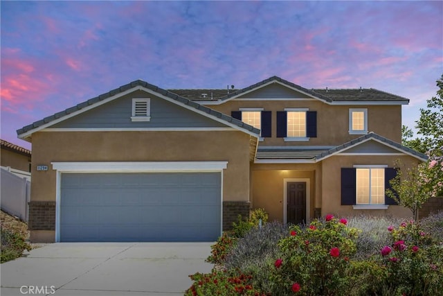 11294 Chappell Way, Beaumont, CA 92223 - traditional home with stucco siding, driveway, brick siding, a garage, and a tile roof