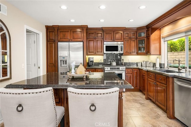 293 N Paseo De Juan, Anaheim Hills, CA 92807 - kitchen with stainless steel appliances, a sink, recessed lighting, a kitchen island, and glass insert cabinets