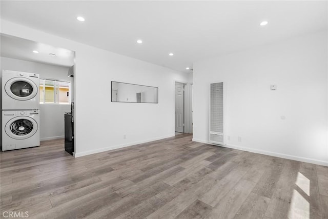 142 S Savannah St, Los Angeles, CA 90033 - unfurnished living room featuring stacked washer / drying machine, a heating unit, recessed lighting, light wood-style floors, and baseboards