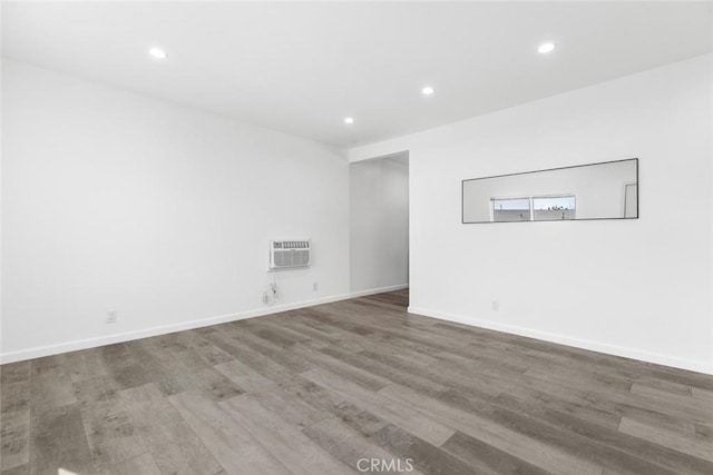 142 S Savannah St, Los Angeles, CA 90033 - empty room with recessed lighting, a wall mounted AC, wood finished floors, and baseboards