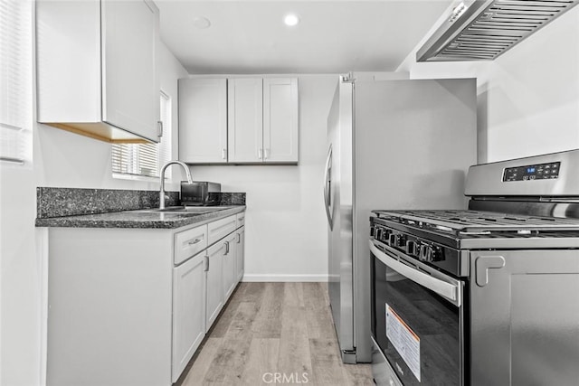142 S Savannah St, Los Angeles, CA 90033 - kitchen with gas stove, a sink, light wood-type flooring, white cabinets, and dark stone countertops
