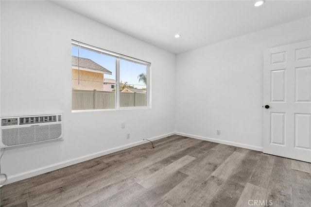 142 S Savannah St, Los Angeles, CA 90033 - unfurnished room with wood finished floors, recessed lighting, baseboards, and a wall mounted AC