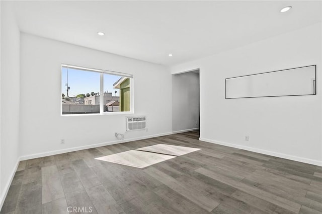 142 S Savannah St, Los Angeles, CA 90033 - empty room with wood finished floors, recessed lighting, baseboards, and an AC wall unit