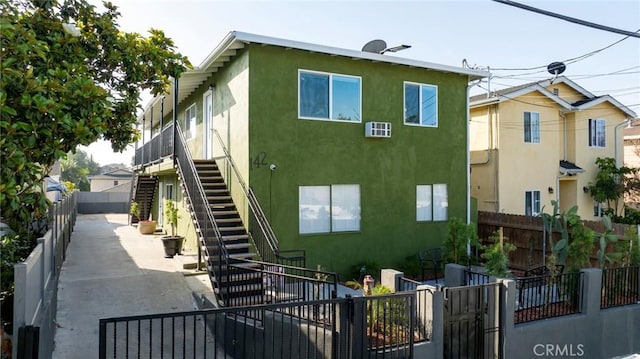 142 S Savannah St, Los Angeles, CA 90033 - view of front of house featuring stairway and stucco siding
