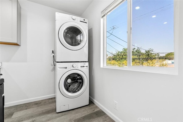 142 S Savannah St, Los Angeles, CA 90033 - washroom featuring estacked washer and dryer, plenty of natural light, and wood finished floors
