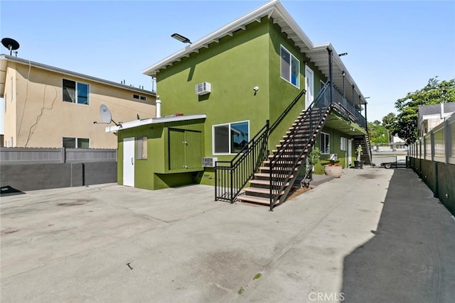 142 S Savannah St, Los Angeles, CA 90033 - rear view of property with stairway and stucco siding