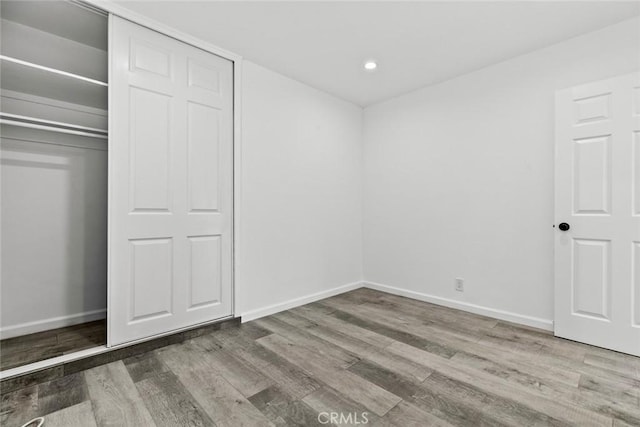 142 S Savannah St, Los Angeles, CA 90033 - unfurnished bedroom with wood finished floors, baseboards, recessed lighting, and a closet