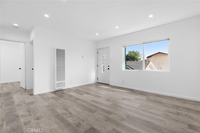 142 S Savannah St, Los Angeles, CA 90033 - spare room with a heating unit, wood finished floors, recessed lighting, and baseboards
