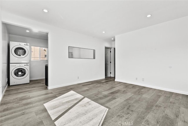 142 S Savannah St, Los Angeles, CA 90033 - unfurnished living room with stacked washer / dryer, recessed lighting, wood finished floors, and baseboards